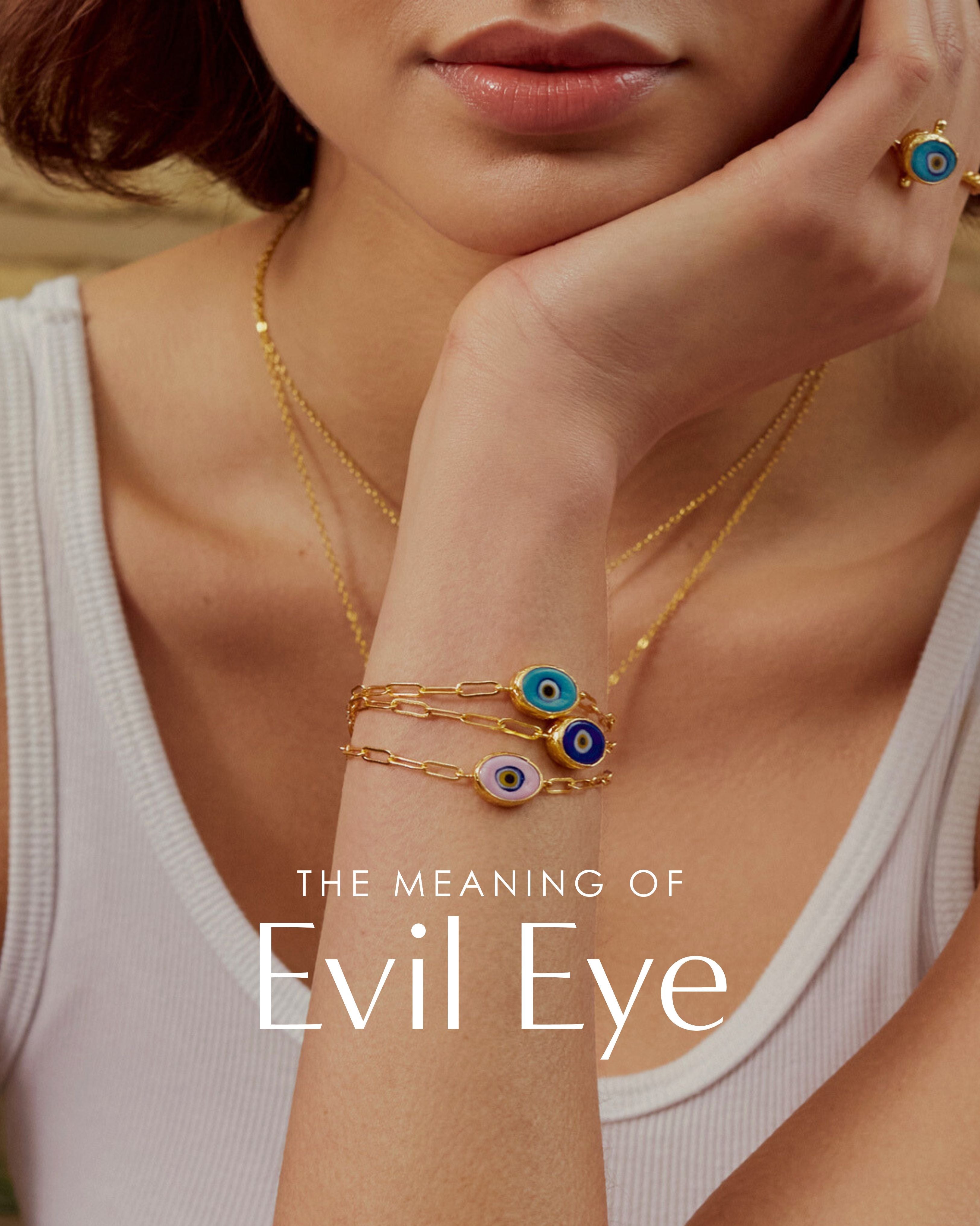 A model wearing evil eye rings and bracelets