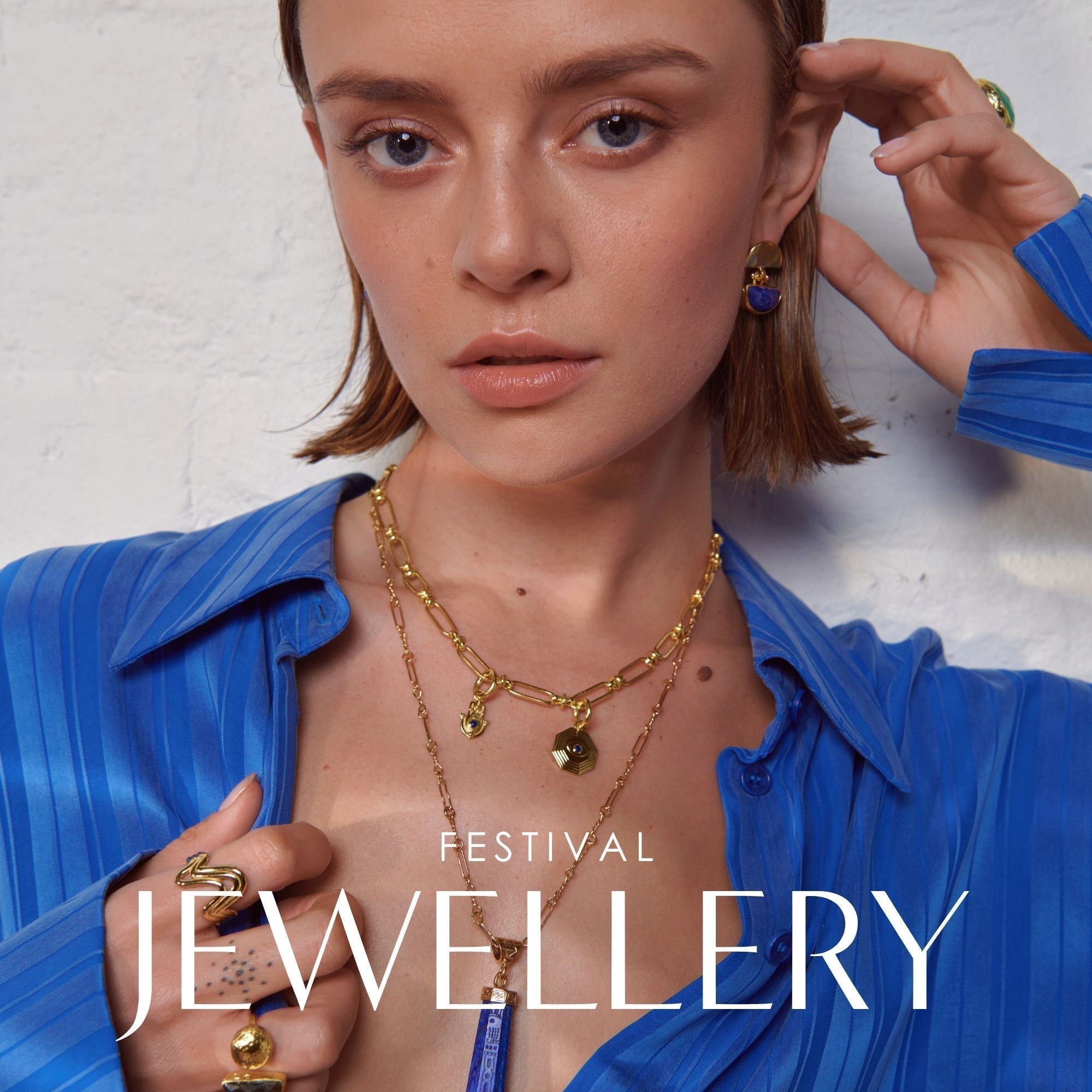 Model wearing layered pendant and charm necklace for festival styling