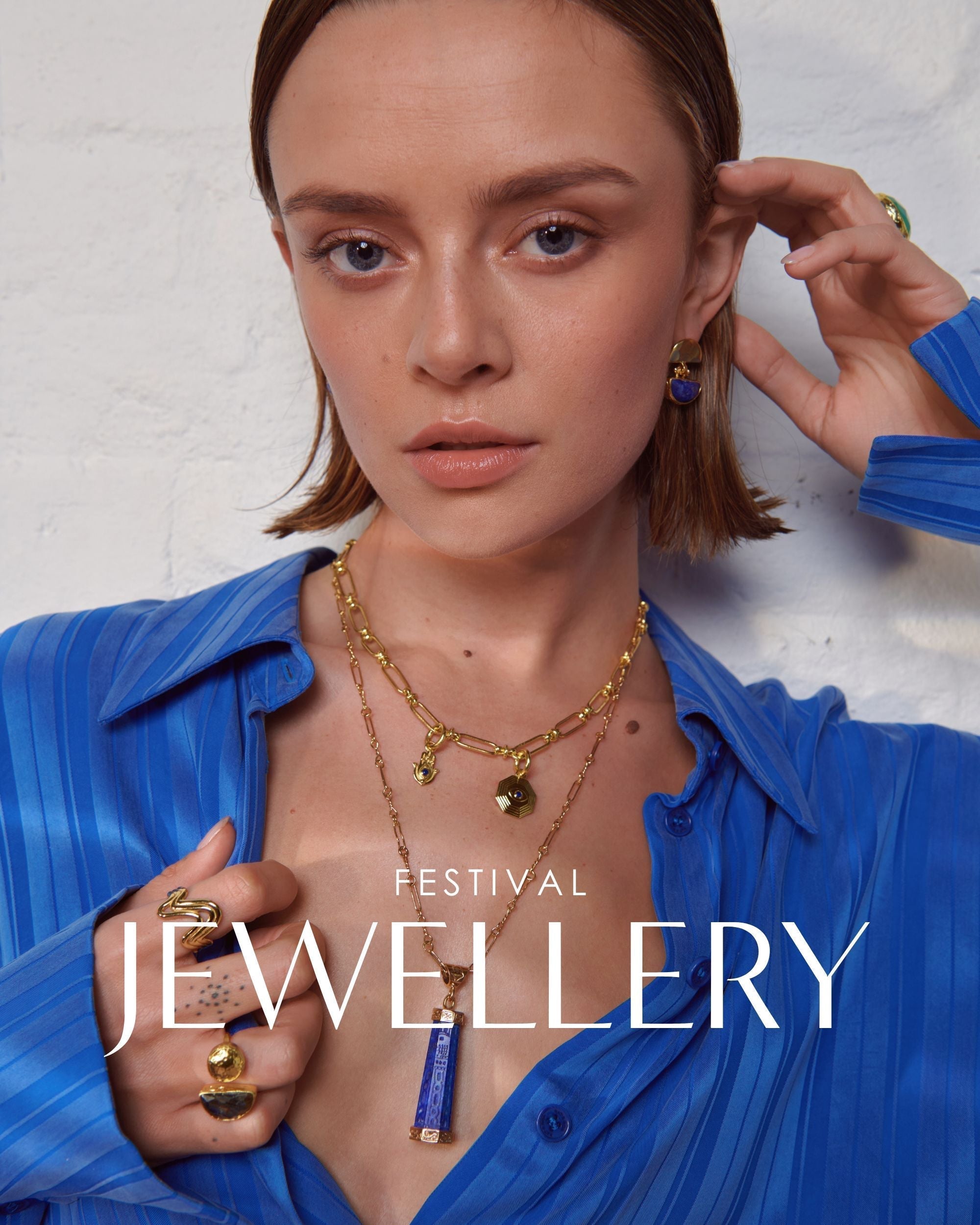 Model wearing layered pendant and charm necklace for festival styling