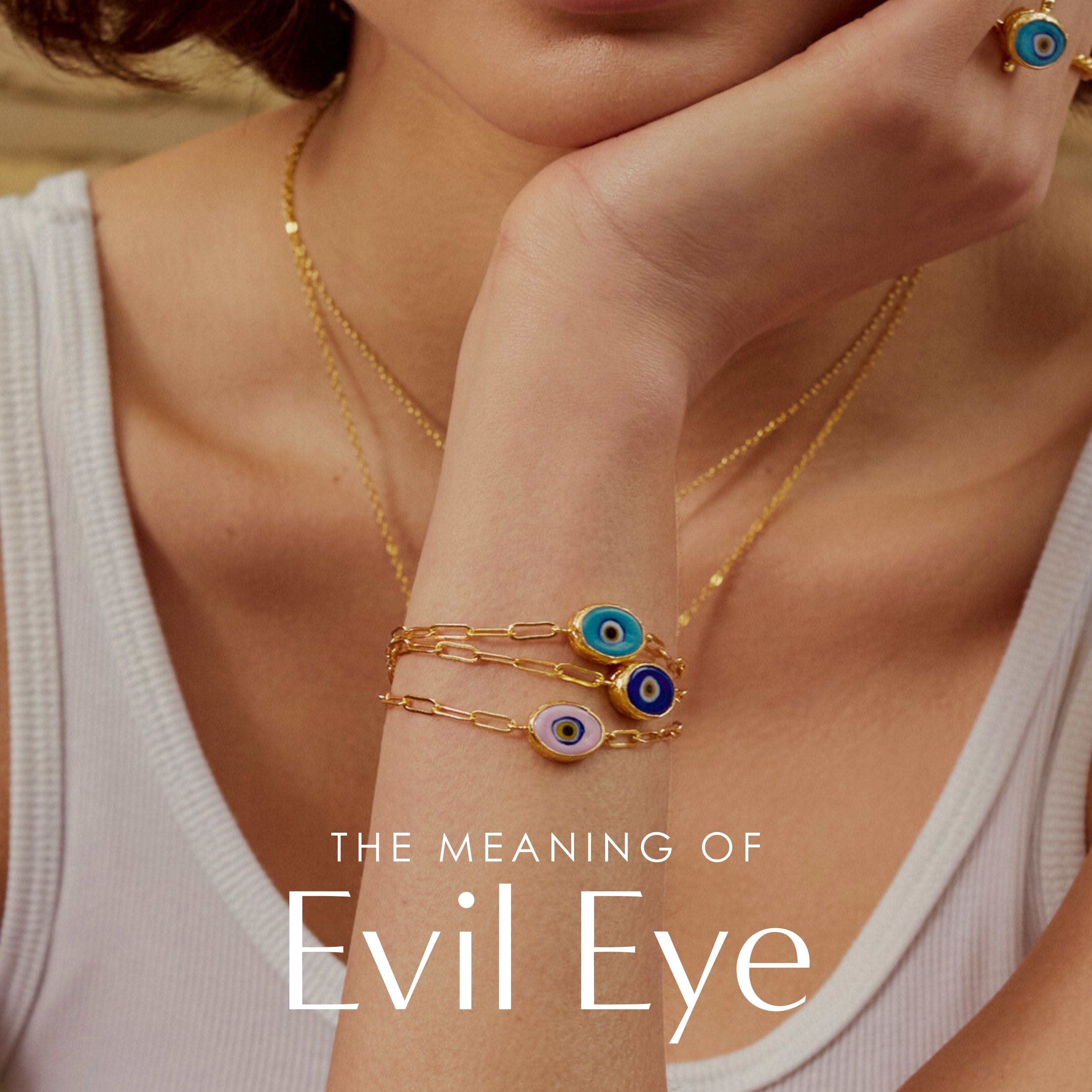 A model wearing evil eye rings and bracelets